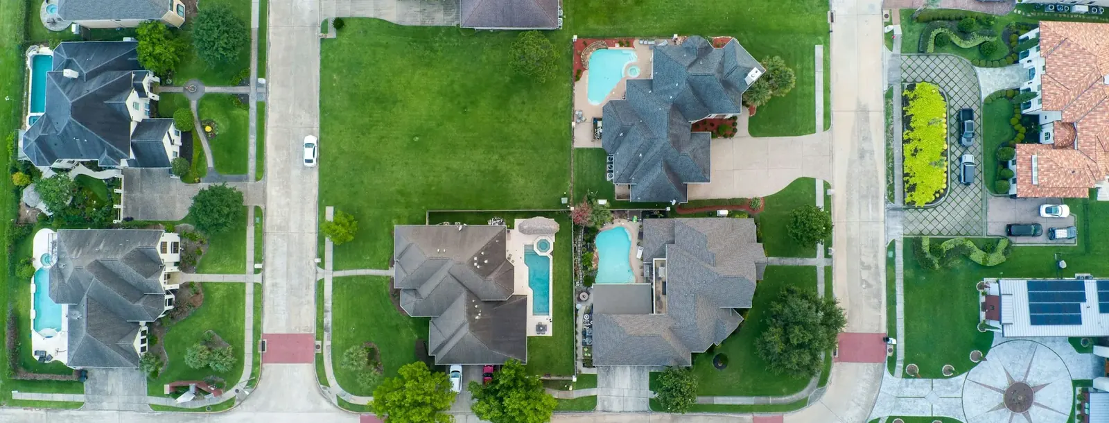 Aerial view of suburban houses, streets and gardens