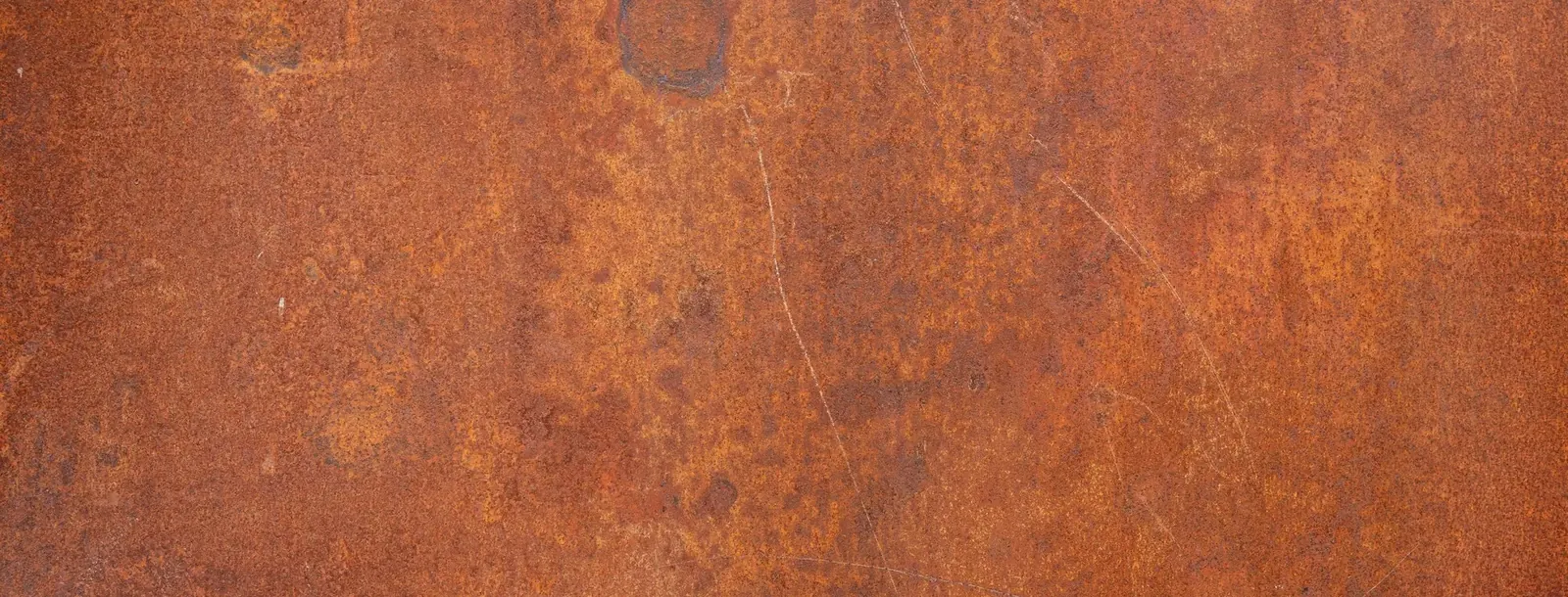 Rust-colored staining on a weathered metal surface