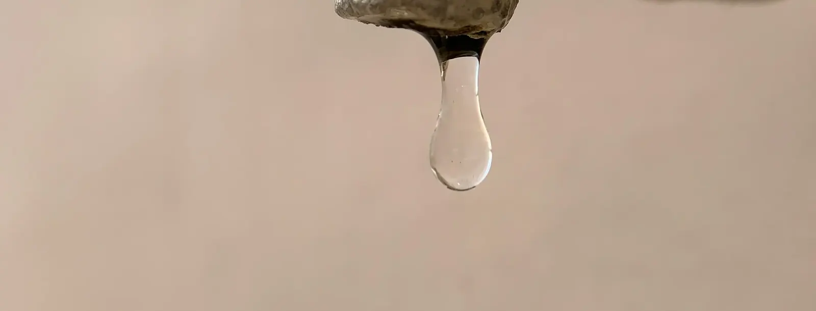 Water dripping from an old brass tap