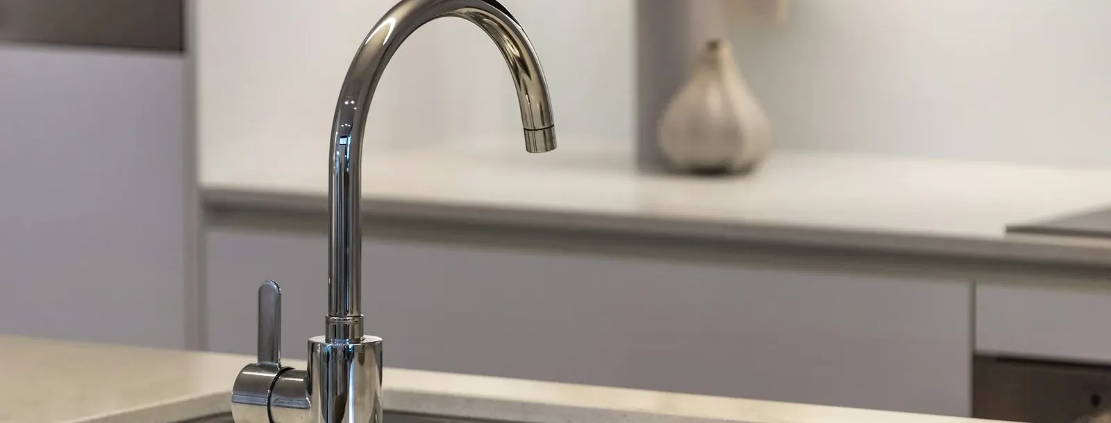 Polished chrome kitchen faucet over a double stainless sink