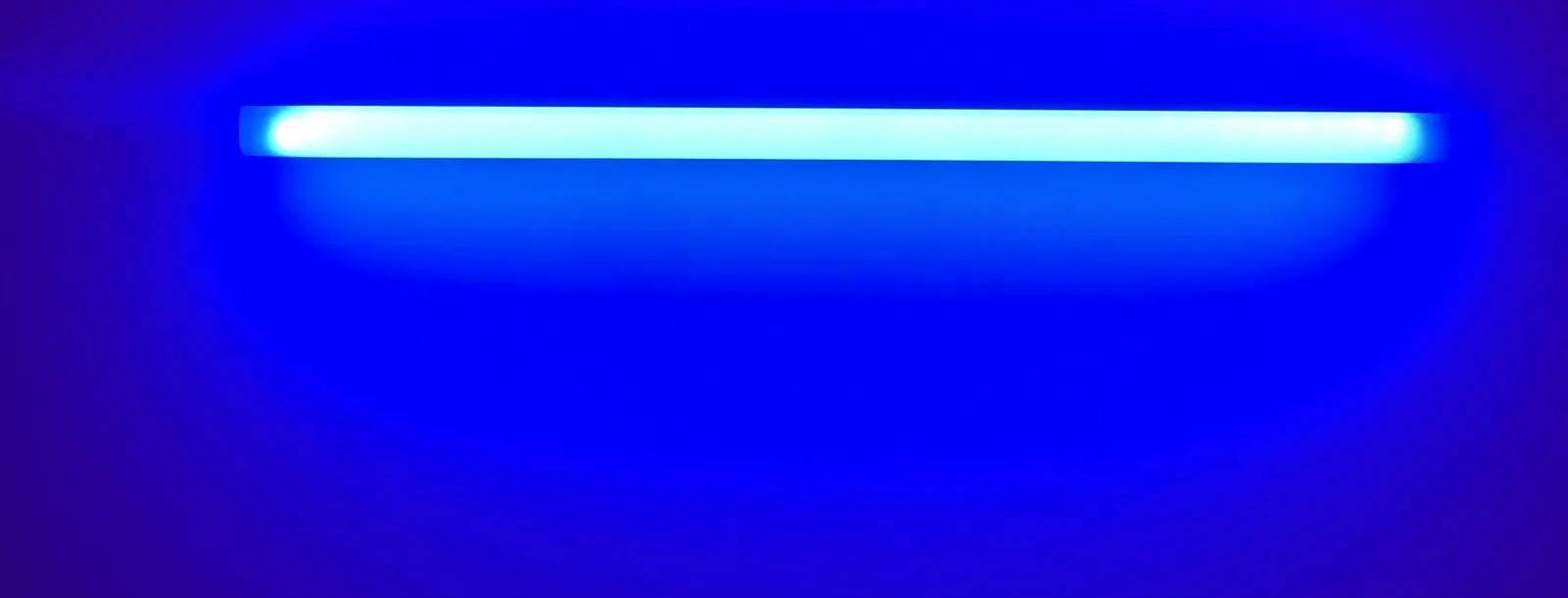 Ultraviolet lamp glowing blue in darkness