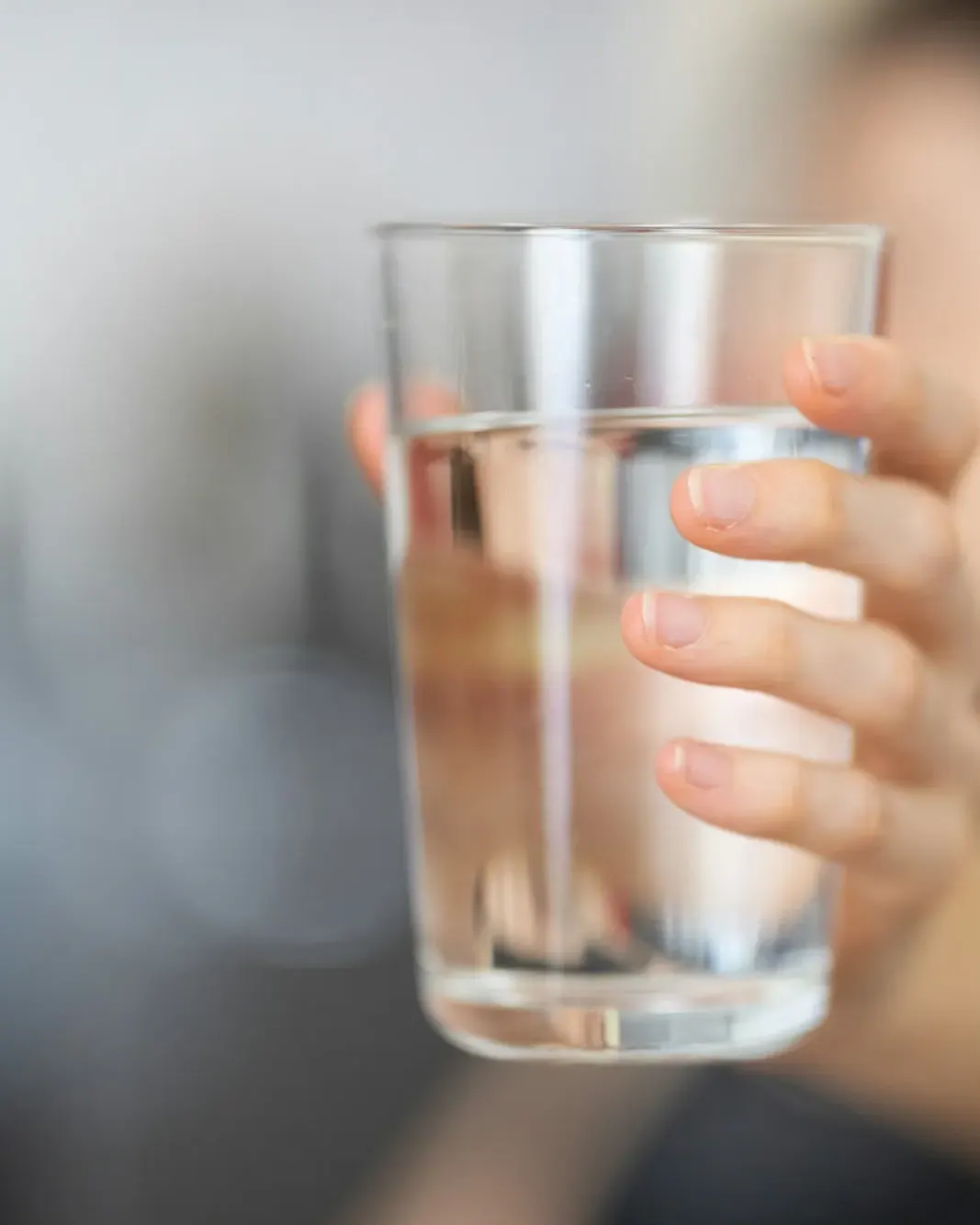Glass of water held up to window light